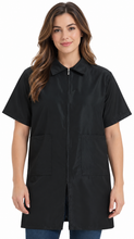 Load image into Gallery viewer, Female nail technician wearing the black cape included with the complete State Board Kit